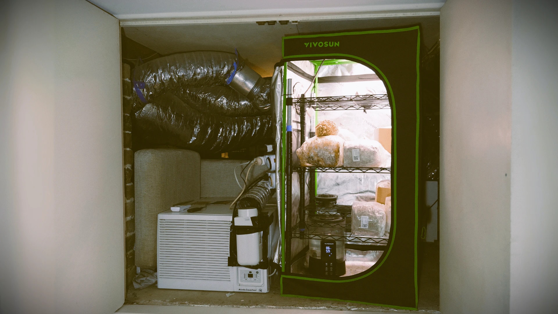 A mushroom grow tent with ducting and a separate air conditioner