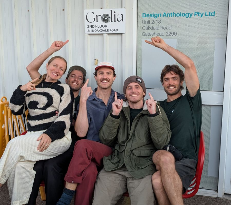 All five Grolia teammates outside the Newcastle workshop beneath the Grolia sign
